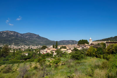 Townscape against clear blue sky