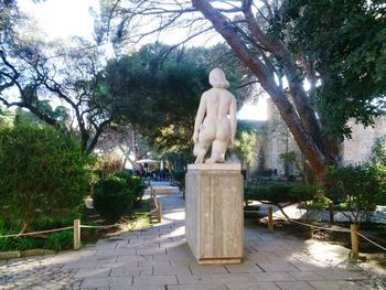 Statue against trees and sky