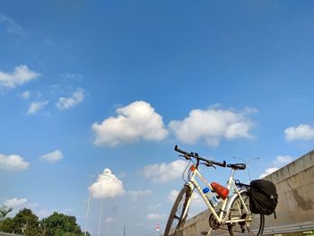 Low angle view of ferris wheel against blue sky