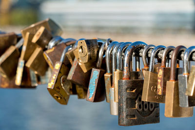 Close-up of padlocks on railing