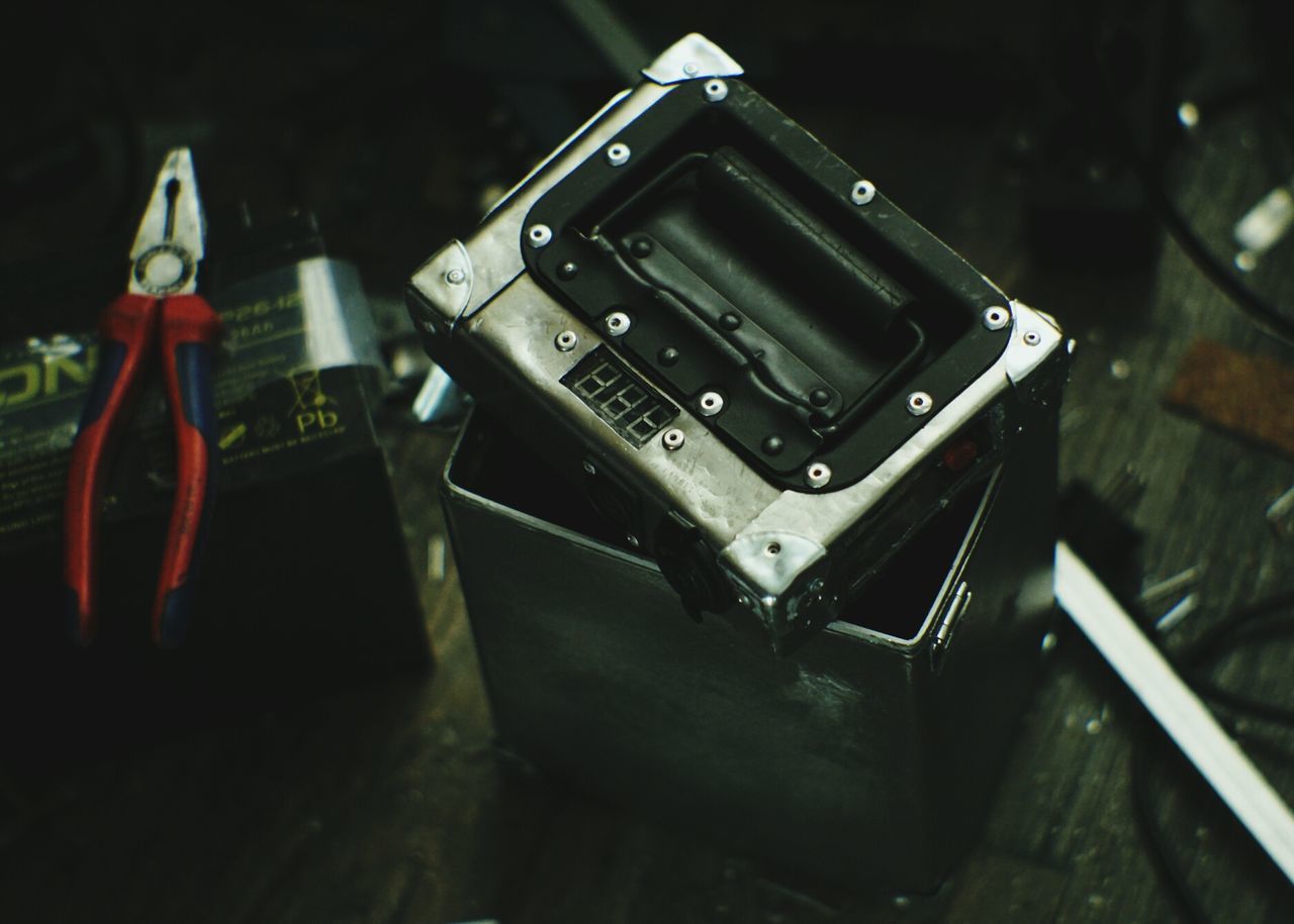 night, close-up, metal, high angle view, no people, technology, focus on foreground, still life, illuminated, old, indoors, selective focus, old-fashioned, table, equipment, retro styled, connection, machinery, metallic