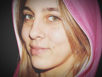 Close-up portrait of smiling young woman wearing hood