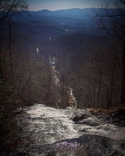 Scenic view of river with mountain in background