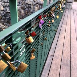 High angle view of padlocks on railing