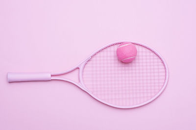 High angle view of dentures over pink background