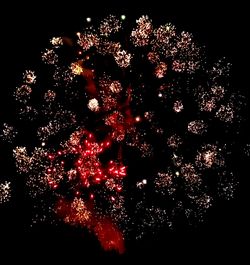 Low angle view of firework display at night