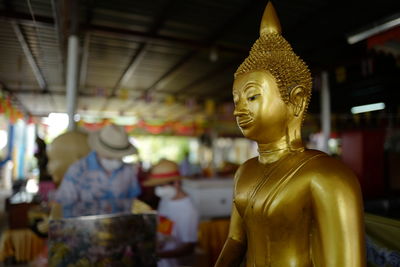 Statue of buddha against building