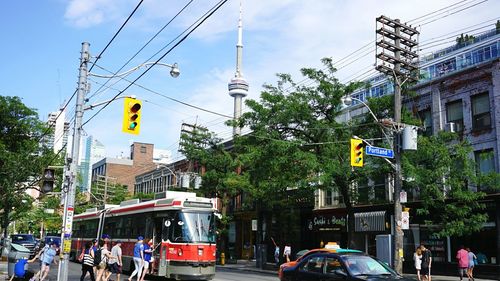 People on city street with cn tower in background