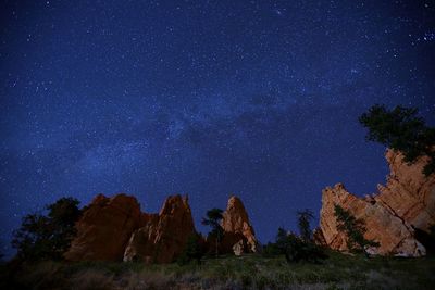 Low angle view of rocks against sky at night