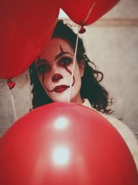 Portrait of woman with red balloons