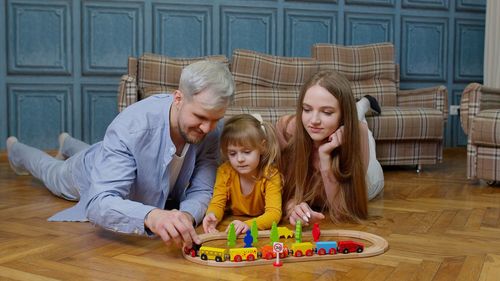 Portrait of happy family sitting on table