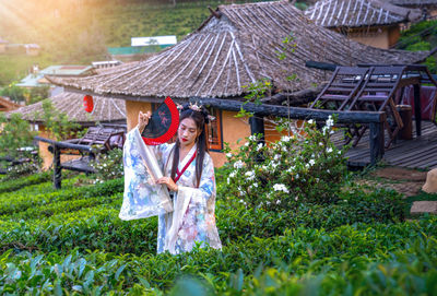 Woman standing by plants