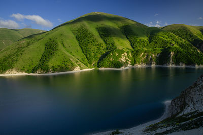 Scenic view of lake and mountains against sky