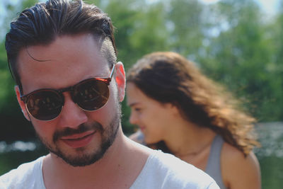 Portrait of smiling young woman wearing sunglasses