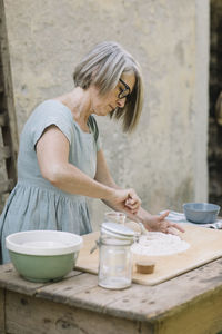 Young woman preparing food on table