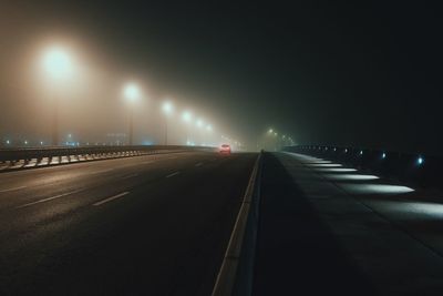 Cars on illuminated road at night