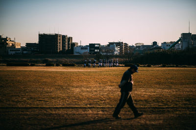 Man in city against clear sky