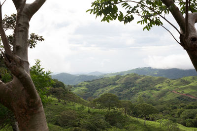 Scenic view of mountains against cloudy sky