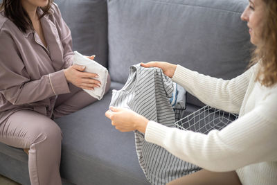 Midsection of woman using mobile phone