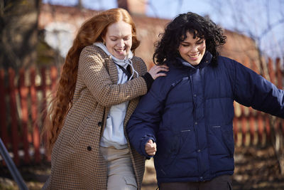 Smiling female friends in park