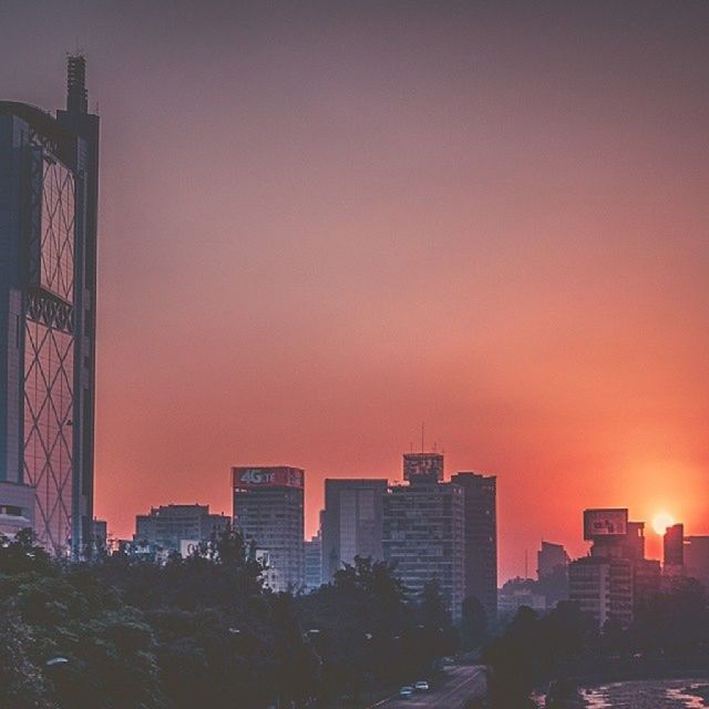 building exterior, architecture, built structure, sunset, city, orange color, skyscraper, cityscape, clear sky, office building, tall - high, copy space, modern, tower, building, city life, residential building, sky, urban skyline, outdoors