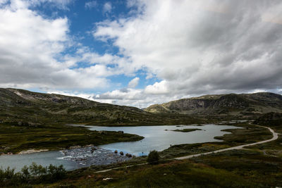 Scenic view of lake and mountains against sky