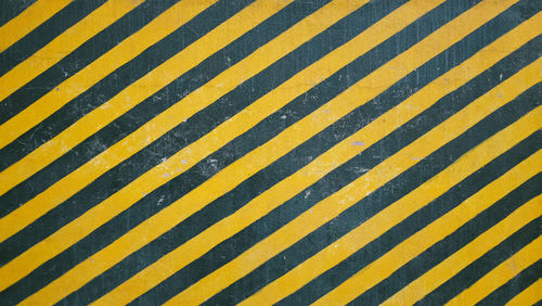 Full frame shot of black and yellow crosswalk