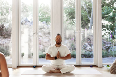 Man practicing yoga in studio