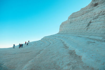 Low angle view of people walking on mountain