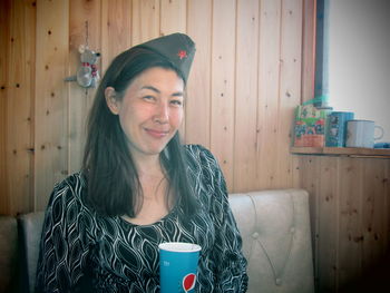 Portrait of a smiling young woman drinking water