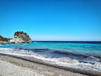 Scenic view of sea against clear blue sky