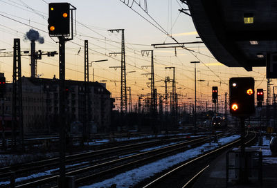 Train on railroad tracks against sky during sunset