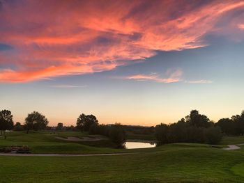View of golf course against sky during sunset