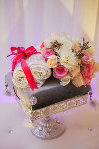 Close-up of pink rose on table