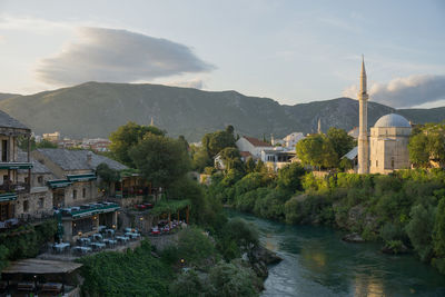 Panoramic view of buildings and mountains against sky in mostar