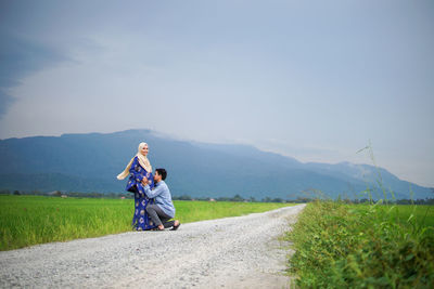 Woman riding motorcycle on road