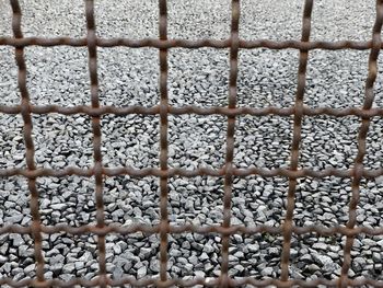 Close-up of metal fence against wall