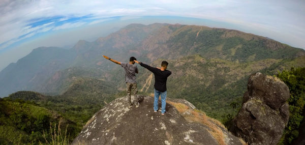 Rear view of men standing on mountain