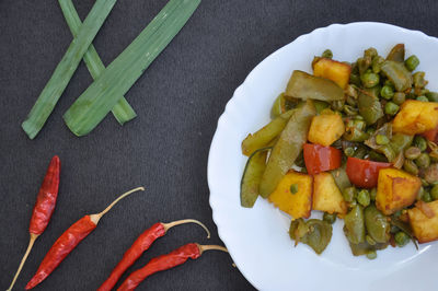 High angle view of chopped vegetables in plate on table