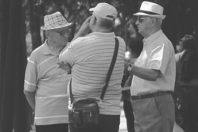 Mature men discussing at park