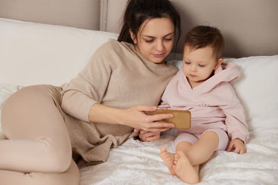 Portrait of cute baby girl sleeping on bed at home