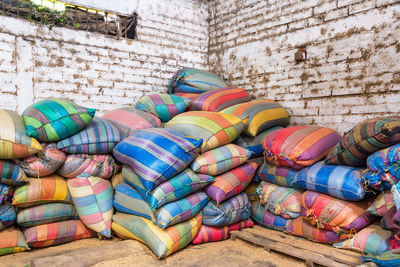 Multi colored sacks by wall