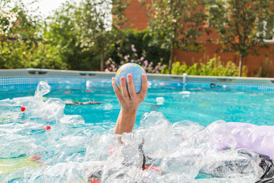 Man standing by swimming pool