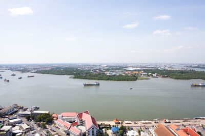 High angle view of townscape by sea against sky