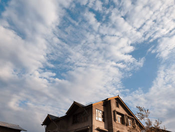 Low angle view of building against cloudy sky