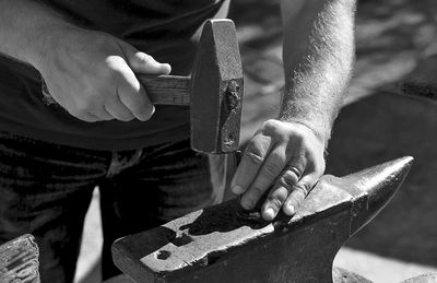 Midsection of man working on wood