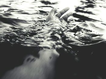 Low section of person swimming in pool