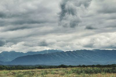 Scenic view of mountains against cloudy sky