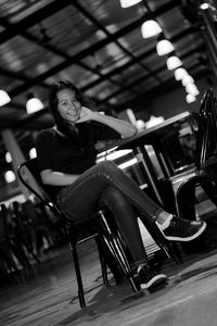 Portrait of young woman sitting on seat