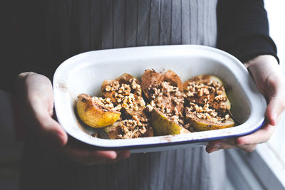 Midsection of woman holding breakfast